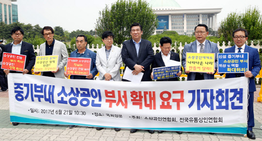 소상공인연합회와 전국유통상인연합회 회원들이 21일 서울 여의도 국회의사당 앞에서 중소벤처기업부 내 소상공인 전담 부서를 '국'에서 '실'로 승격할 것을 요구하는 기자회견을 하고 있다.  소상공인연합회 제공